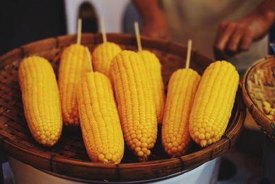 Midsection of man selling corns at market