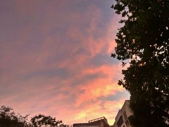 High section of built structure against cloudy sky at sunset