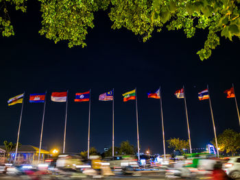 Cars on illuminated street lights in city at night