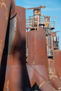 Rusty metal in factory against sky