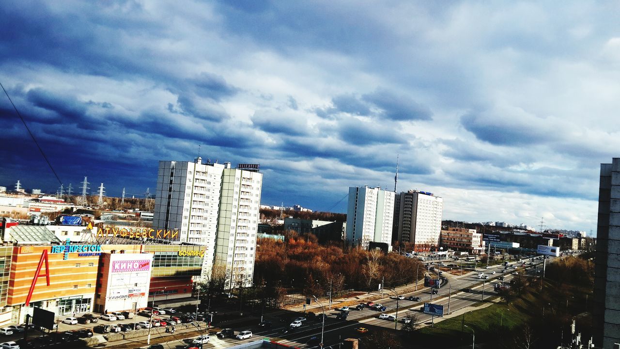 building exterior, city, architecture, built structure, skyscraper, cityscape, sky, tall - high, modern, cloud - sky, office building, tower, urban skyline, cloudy, city life, building, high angle view, financial district, cloud, residential building