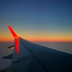 Cropped image of airplane flying over clouds