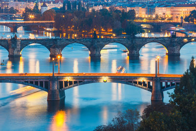 Arch bridge over river at night