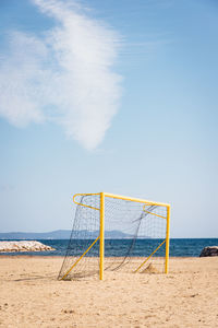 A football cage on beach against sky. a football goal on beach. beachsoccer