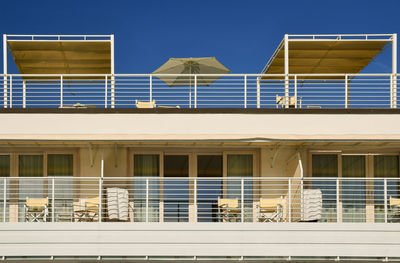 Low angle view of modern building against clear blue sky