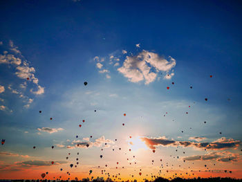 Low angle view of silhouette birds flying against sky during sunset