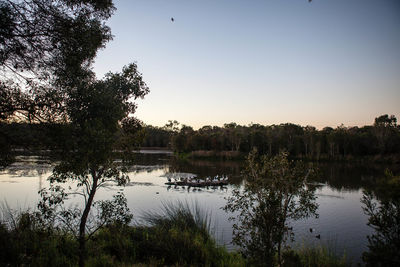 Scenic view of lake against sky at sunset