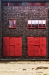 Red window on brick wall