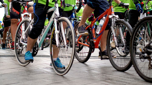 Low section of women with bicycle on street