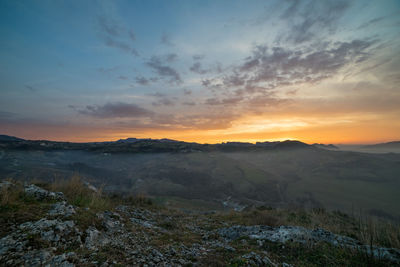 Scenic view of landscape against sky during sunset