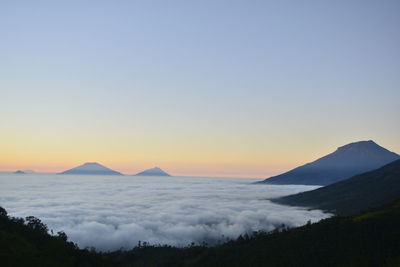 Scenic view of silhouette mountains against sky during sunset