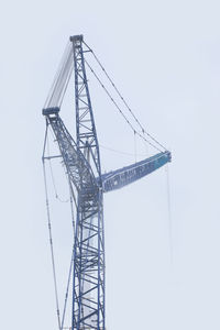 Low angle view of crane against sky