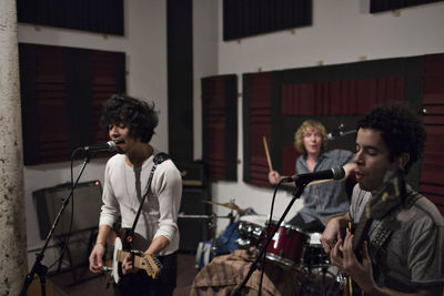 Musicians rehearsing at recording studio