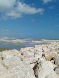 Rocks on beach against sky