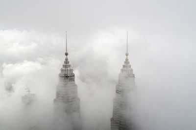 Skyscraper amidst clouds