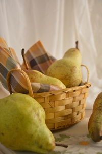 Close-up of pears in basket on table