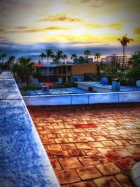 Scenic view of swimming pool against sky at sunset