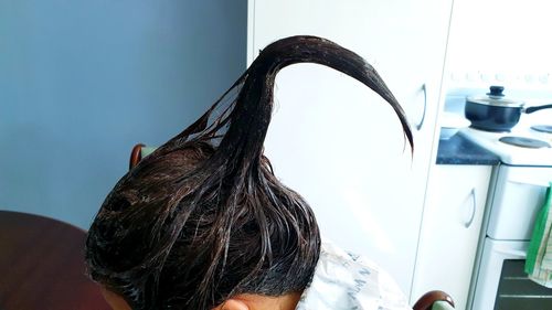 Rear view of woman at home