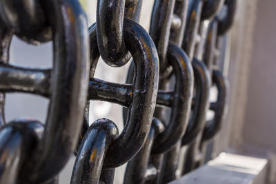 Shined metal black painted chains row. industrial equipment parts