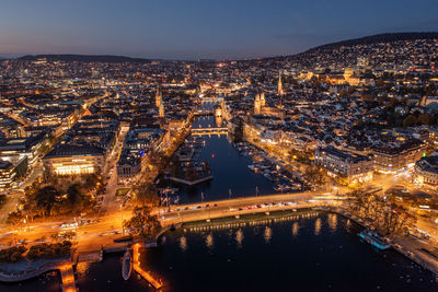 High angle view of illuminated cityscape against sky at night