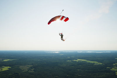 Person paragliding against sky