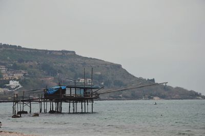 View of calm sea against mountain range