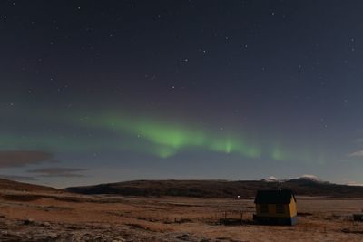 Scenic view of land against sky at night