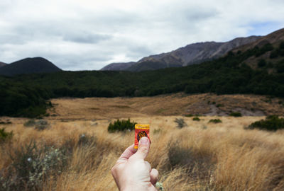 Person holding umbrella on mountain