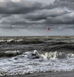 Scenic view of sea against cloudy sky
