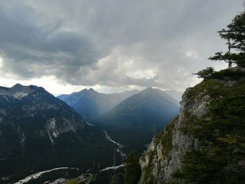 Scenic view of valley and mountains against sky