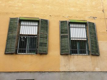 Low angle view of yellow window on building