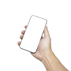 Midsection of person holding mobile phone against white background