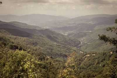 High angle view of valley and mountains against sky