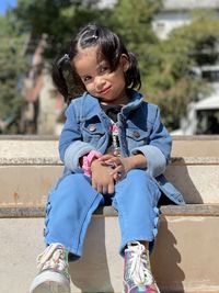 Portrait of boy sitting on staircase