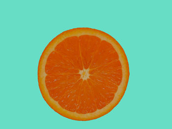 Close-up of orange slice against white background