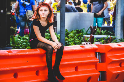 Full length of young woman standing outdoors