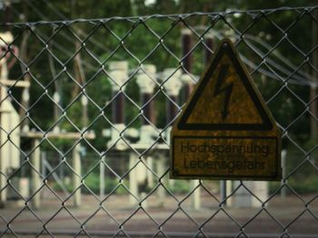 High voltage warning sign on chainlink fence