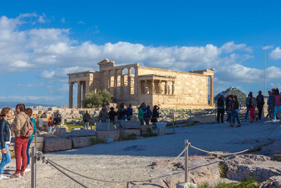 Tourists listening to explanations from a guide in the acropolis, athens, greece