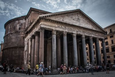 People in front of historical building