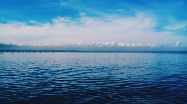 water, waterfront, tranquil scene, sea, scenics, sky, blue, tranquility, beauty in nature, rippled, nature, horizon over water, idyllic, cloud - sky, cloud, seascape, outdoors, no people, calm, reflection