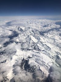 Aerial view of snowcapped mountain against sky