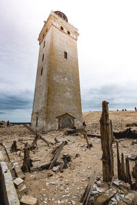 Low angle view of old lighthouse against sky