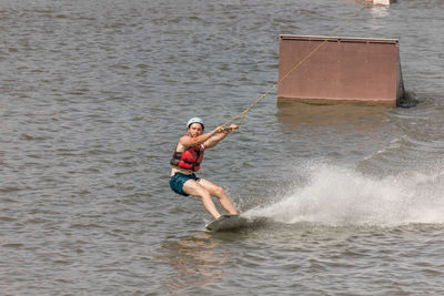 Man kite boarding in river