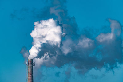 Low angle view of smoke stack against sky