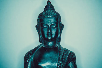 Close-up of statue against blue background