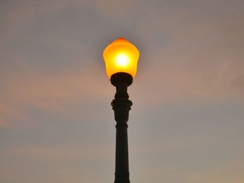 Low angle view of street light against orange sky