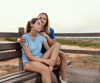 Young woman sitting on bench