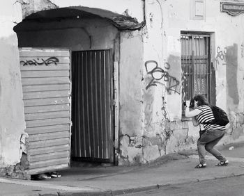 Full length of woman standing by railing