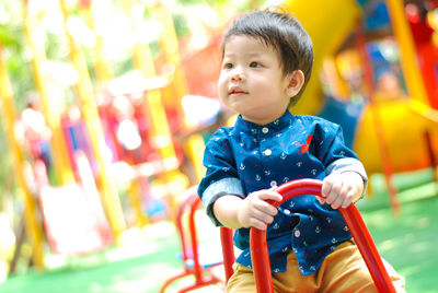 Close-up of boy sitting at playground