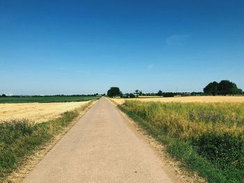 Empty road along countryside landscape